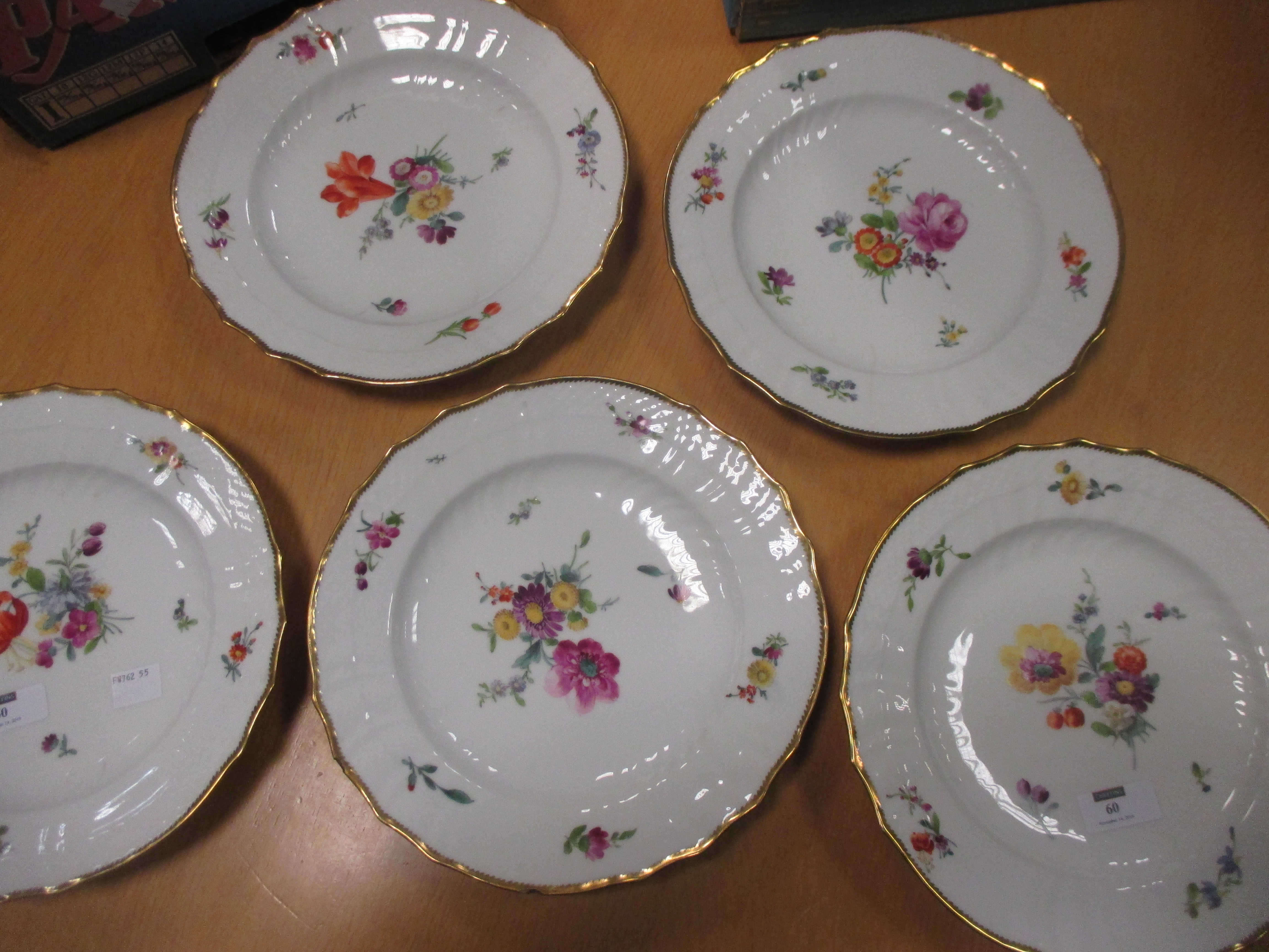 A set of sixteen continental porcelain plates painted with flowers