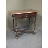 A late 17th century oak side table with single drawer, with turned legs joined by an x framed