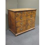An 18th century walnut chest of drawers, comprising of two short over three long drawers on bun feet