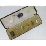 An amethyst brooch and a quantity of loose large faceted gemstones,