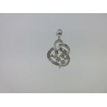 An asymmetric diamond pendant set in 9ct white gold,