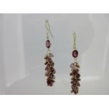 A pair of waterfall earpendants set with garnets,