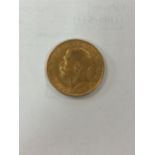 A George V gold sovereign,