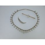 An antique moonstone fringe necklace together with two moonstone brooches,