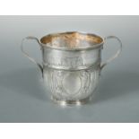 A Queen Anne Britannia silver two handled porringer,