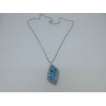 A blue topaz and diamond pendant and chain cased by Cellini,