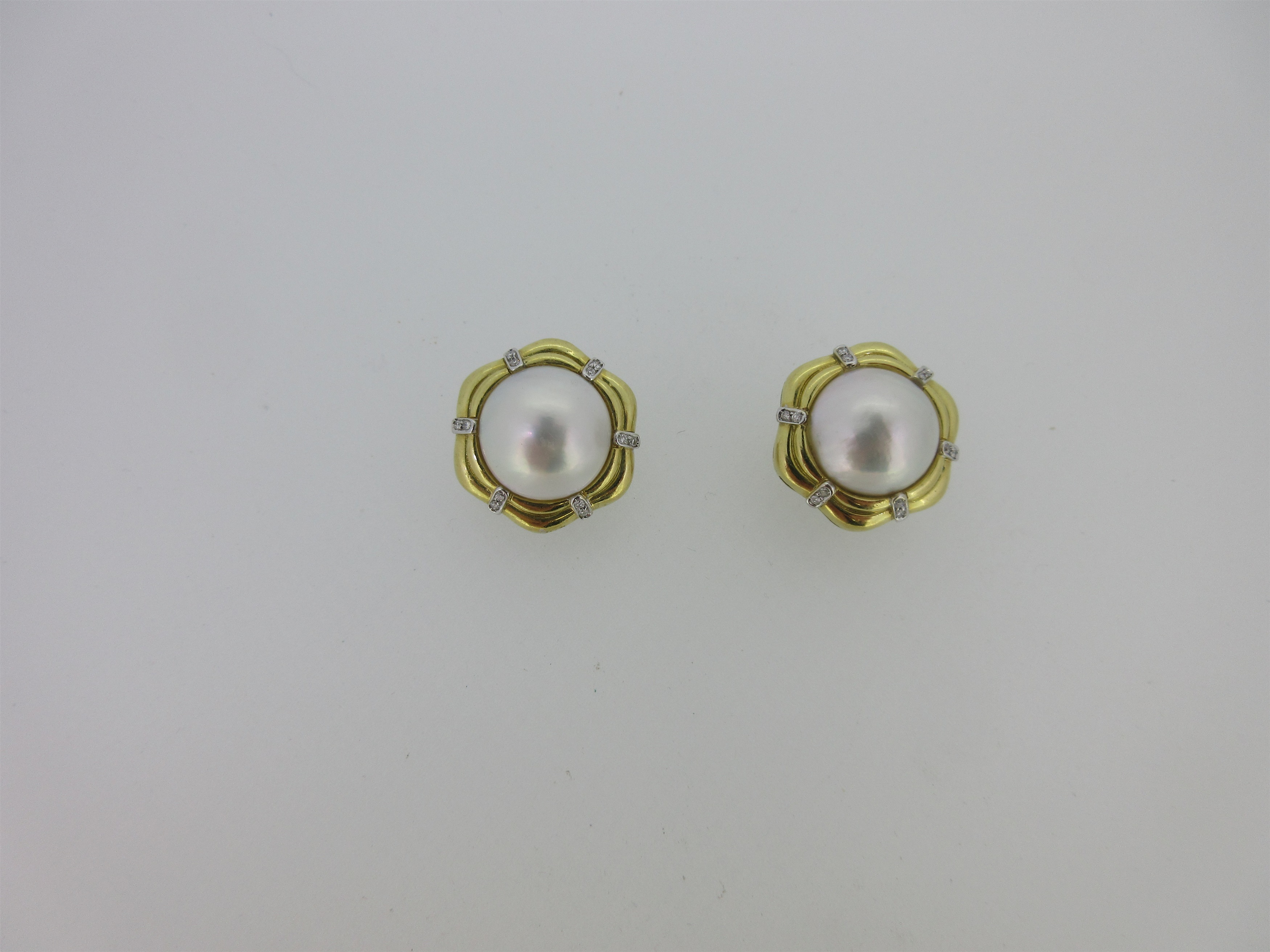 A pair of 18ct gold mabé pearl and diamond earclips,