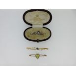 A diamond and enamel racing horse tie pin and two other bar brooches,