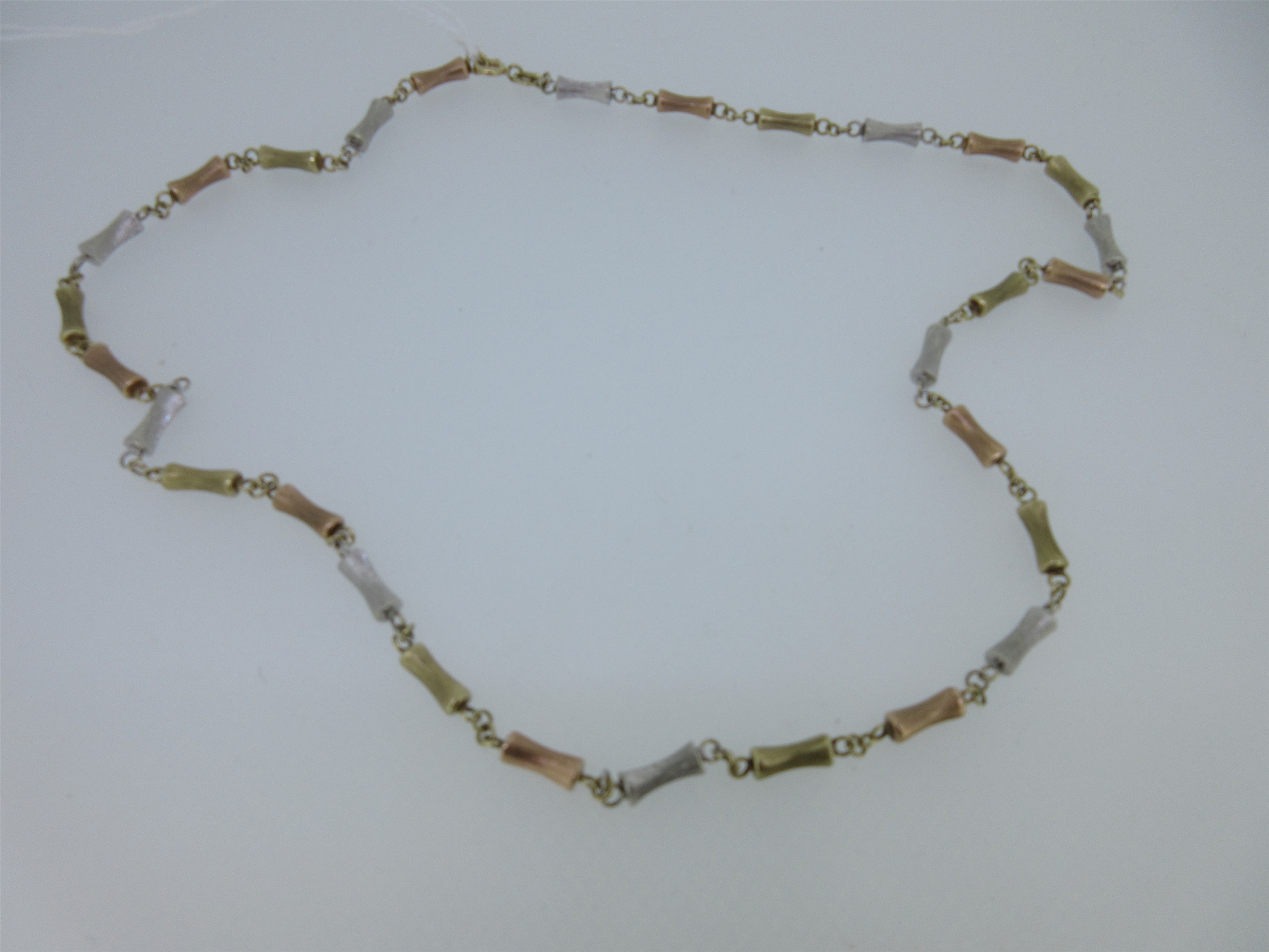A tri-coloured gold necklace by Mappin & Webb,