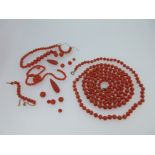 A long coral bead necklace together with various loose coral beads and drops,