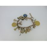 A 9ct gold charm bracelet with eighteen charms,