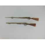 Two tricolour gold double barrelled shotgun brooches,