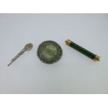 A circular jadeite clip, a nephrite jade brooch and a replica anointing spoon brooch,