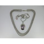 A Victorian silver locket together with a three row chain necklace,