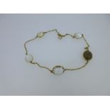 A chain necklace set with five hardstone accents,