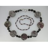 A garnet and cultured pearl necklace together with another garnet and stone necklace,