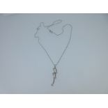 An 18ct white gold and diamond pendant with chain,