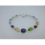 A modern multi gem set bracelet,