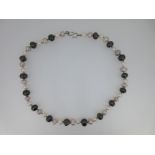 A three coloured cultured pearl necklace,