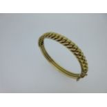 A hinged bangle with fixed chain link front stamped '15',