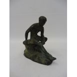 A verdigris patinated brass seated figure.