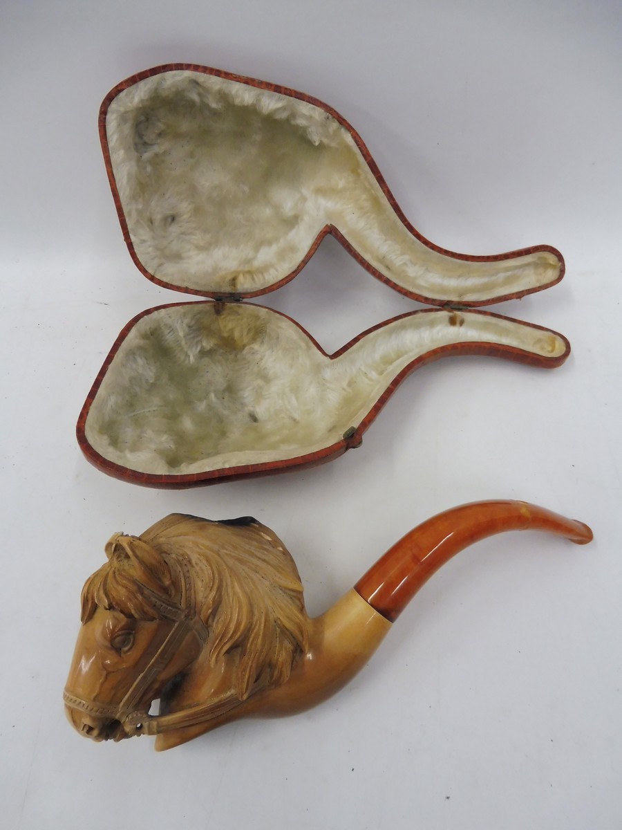 A good quality cased meerschaum pipe, the bowl ornately carved as a horse head.