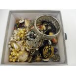 A small box of assorted costume jewellery including silver.