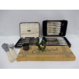 A cased set of six MOP handled fish eaters, a cased set of six silver handled knives and an