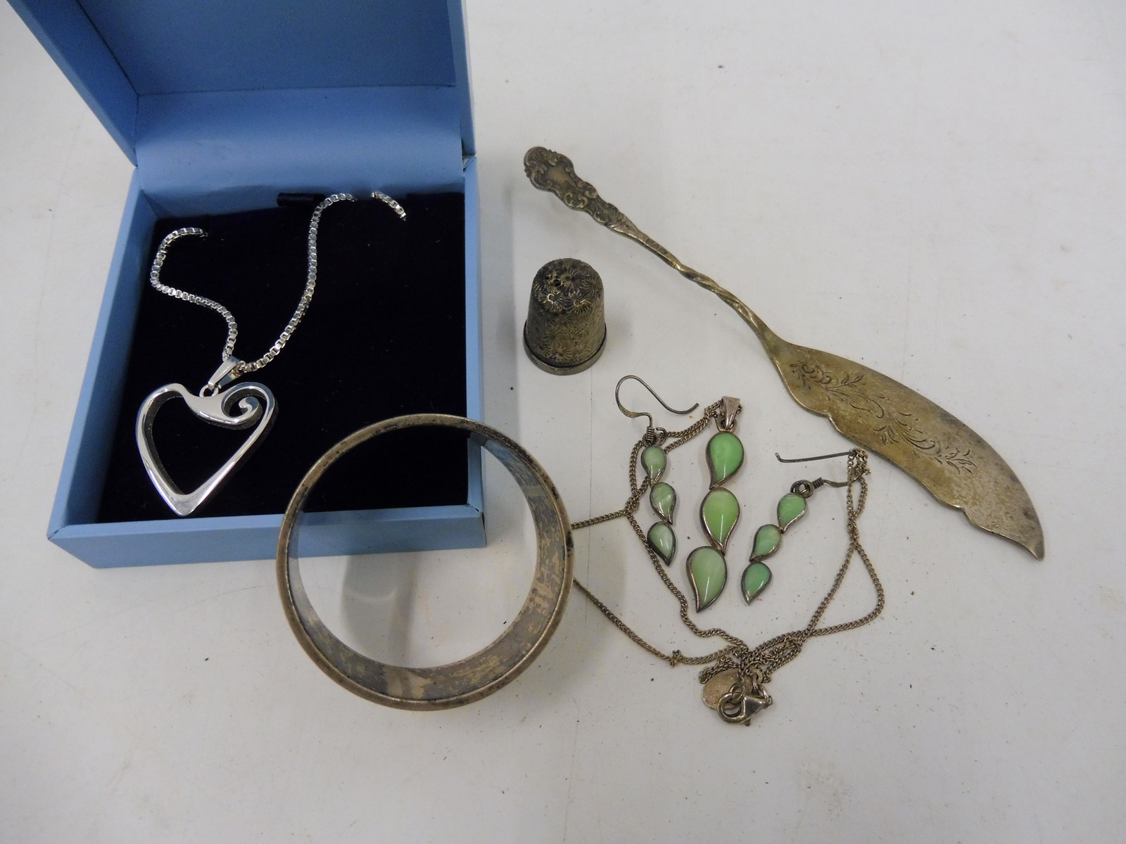 A small selection of silver including an ornate butter knife, Chester hallmark, a necklace and