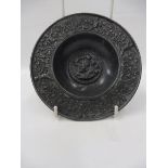 An unusual 19th Century or earlier circular embossed lead miniature alms style dish decorated with