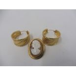 A pair of 9ct gold hooped earrings and a 9ct gold mounted cameo brooch.