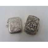 A sterling silver pill pot, the lid in deep relief depicting figures and a silver vesta case.