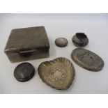 A square silver cigarette case, a small silver heart shaped dish, three silver dressing table jar