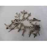 A silver charm bracelet comprising 12 miniature aeroplanes and a padlock, the charms include