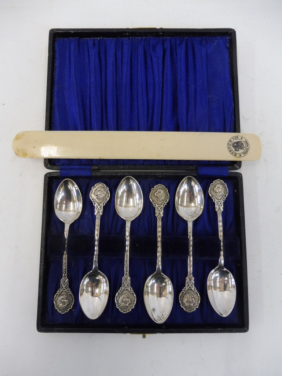 A cased set of six white metal spoons advertising Kynoch and a page turner, also promoting the