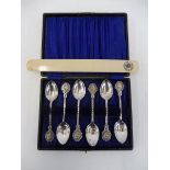 A cased set of six white metal spoons advertising Kynoch and a page turner, also promoting the