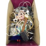 A box of assorted costume jewellery.