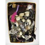 A tin of assorted costume jewellery.