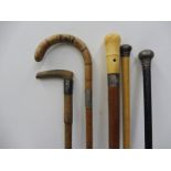 Five silver or white metal mounted walking canes.