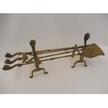 A good quality 19th Century companion and andiron set, the handles terminating in well detailed