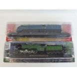 Two boxed model locomotives depicting the Mallard and The Flying Scotsman.