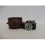 A miniature leather cased Japanese 1960s camera.