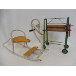 A Tri-ang tinplate and wooden mangle plus a tinplate Mobo rocker in the form of a swan.