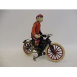 A contemporary German tinplate clockwork model of a motorcycle and its rider.