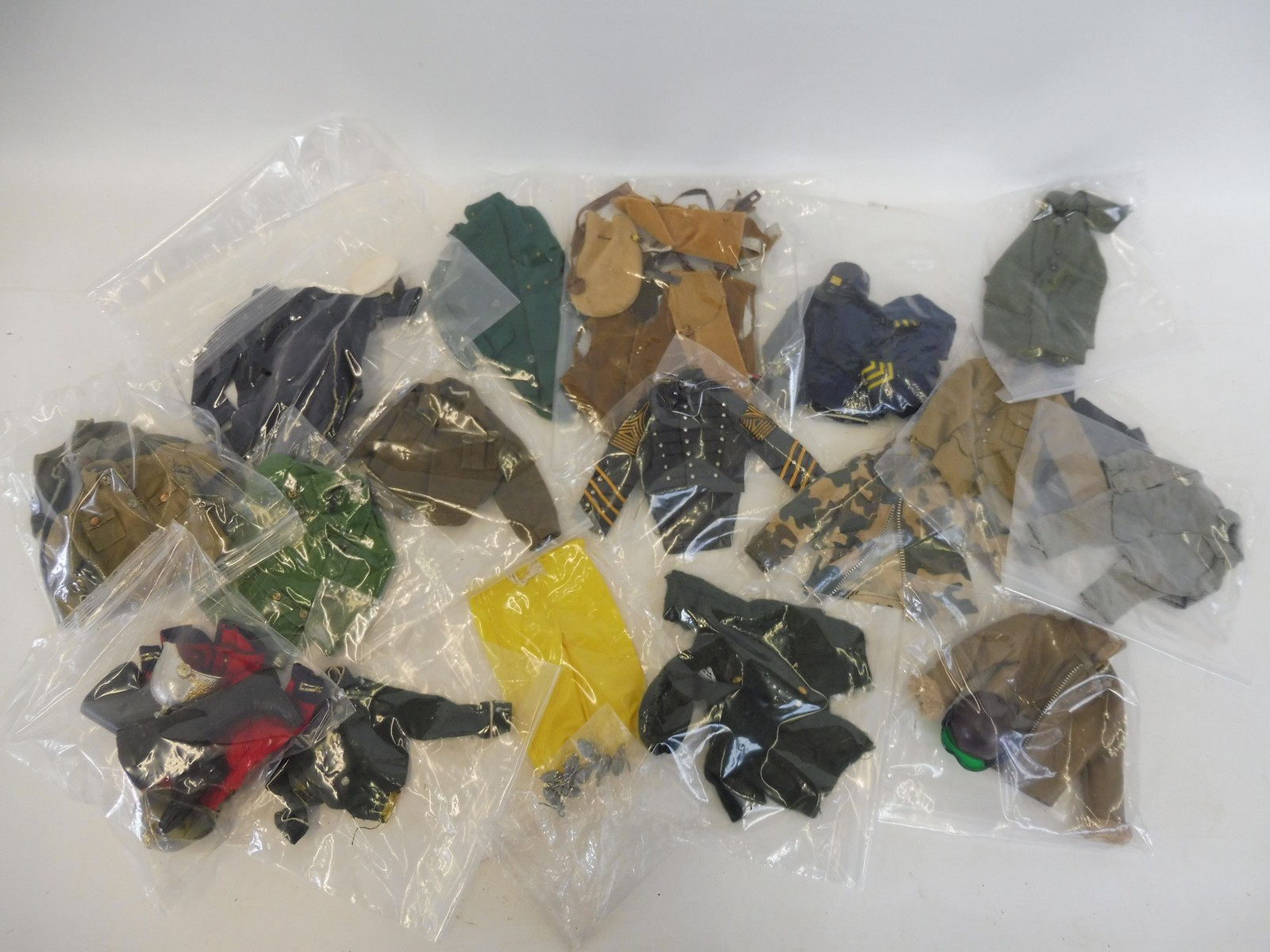 A box of Action Man uniforms generally in good condition to include Lifeguard and 7th Calvary etc.