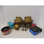 A collection of plastic Teenage Mutant Ninja Turtle figures and accessories, two tins of plastic toy