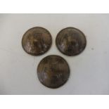 Three WWI trench art coins moulded into army issue helmets.