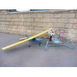 A tinplate child's rocker and a partial remote controlled model airoplane.
