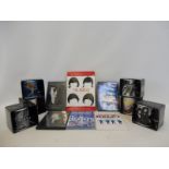 A box of Beatles collectors' mugs and a DVD box set 'Help' etc.
