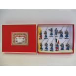 A Qualite Francais boxed set of twelve French marching colonial infantry with band, drum etc. in